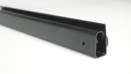 Black metal strip with textured surface on a white background