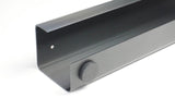 Gray soundbar with a control knob on a white background