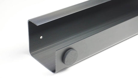 Gray soundbar with a control knob on a white background
