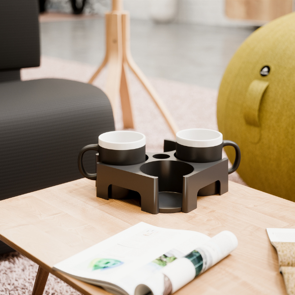 Modern carry tray with two black mugs on a wooden coffee table in a contemporary office lounge