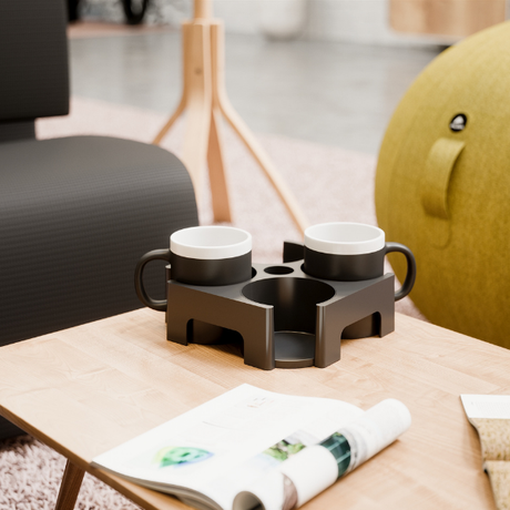 Modern carry tray with two black mugs on a wooden coffee table in a contemporary office lounge
