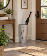 Alba Rainy Oval Umbrella Stand in a modern entryway holding a black umbrella