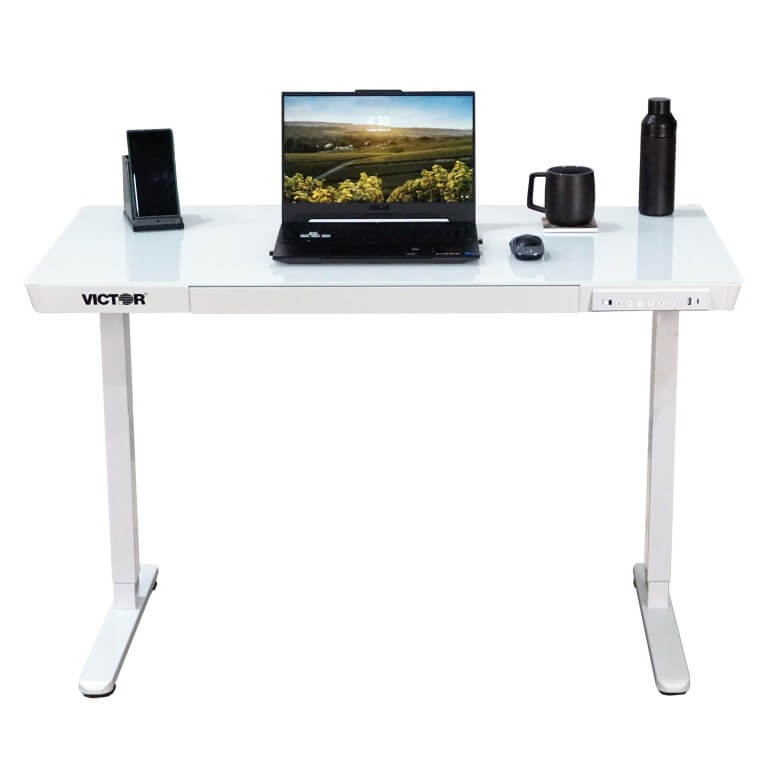 White desk with laptop, mug, and other items on a white background