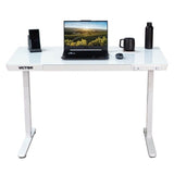 White desk with laptop, mug, and other items on a white background