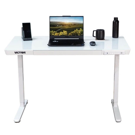 White desk with laptop, mug, and other items on a white background
