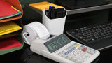 Office desk with a Sharp printing calculator, paperwork organizer, keyboard, and pen holder