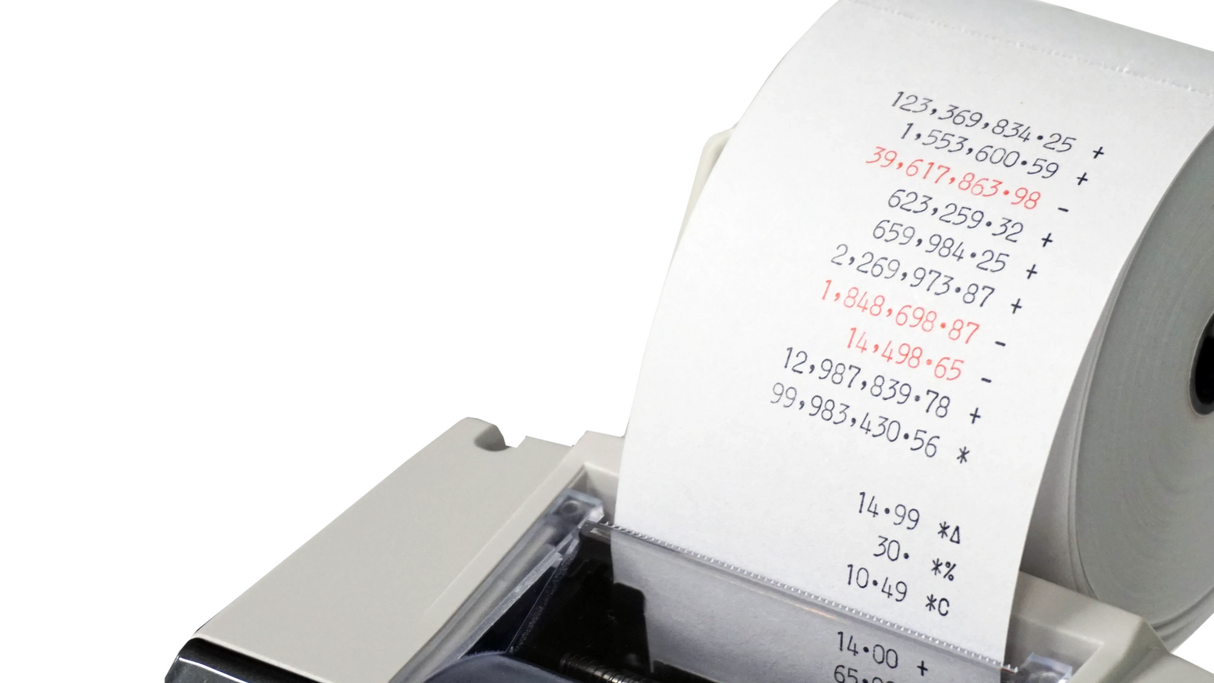 Close-up of calculator printing tape with printed numbers, suitable for office or school use
