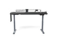 Adjustable standing desk with black tabletop, grey legs, and workspace organizer accessories.