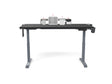 Black height-adjustable standing desk with workspace organizers and modern accessories