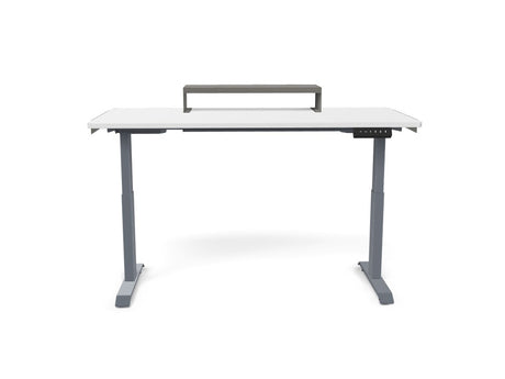Adjustable standing desk with white tabletop, gray legs, and monitor riser for office workspace