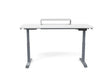 White electric standing desk with raised monitor shelf and digital control panel