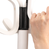 Hand assembling white wood coat stand with multiple hooks and sturdy black connector