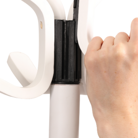 Hand assembling white wood coat stand with multiple hooks and sturdy black connector