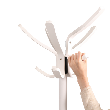 Hand assembling modern white wood coat stand with multiple hooks