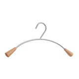 Curved metal clothes hanger with wooden ends on a white background