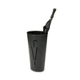 Black metal oval umbrella stand with modern cutout design holding a closed black umbrella