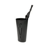 Black metal oval umbrella stand with modern cutout design holding a closed black umbrella