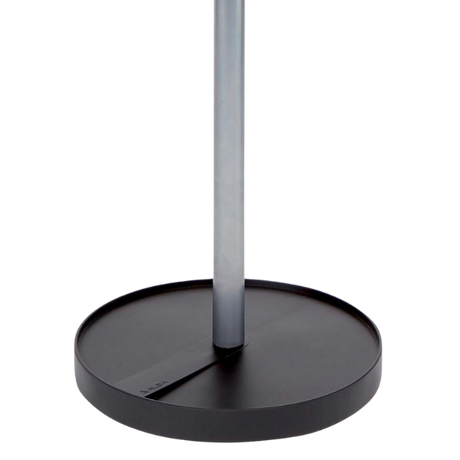 Close-up of a modern coat stand base with a round black platform and silver pole