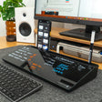 Black desk organizer with glass dry erase board for notes, phone stand, pen holder on office desk