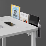 Practiko Otis Edge in white mounted to a desk with books, tablet, and phone