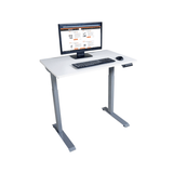 White adjustable desk with computer setup on a white background