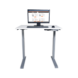 White adjustable desk with computer setup on a white background
