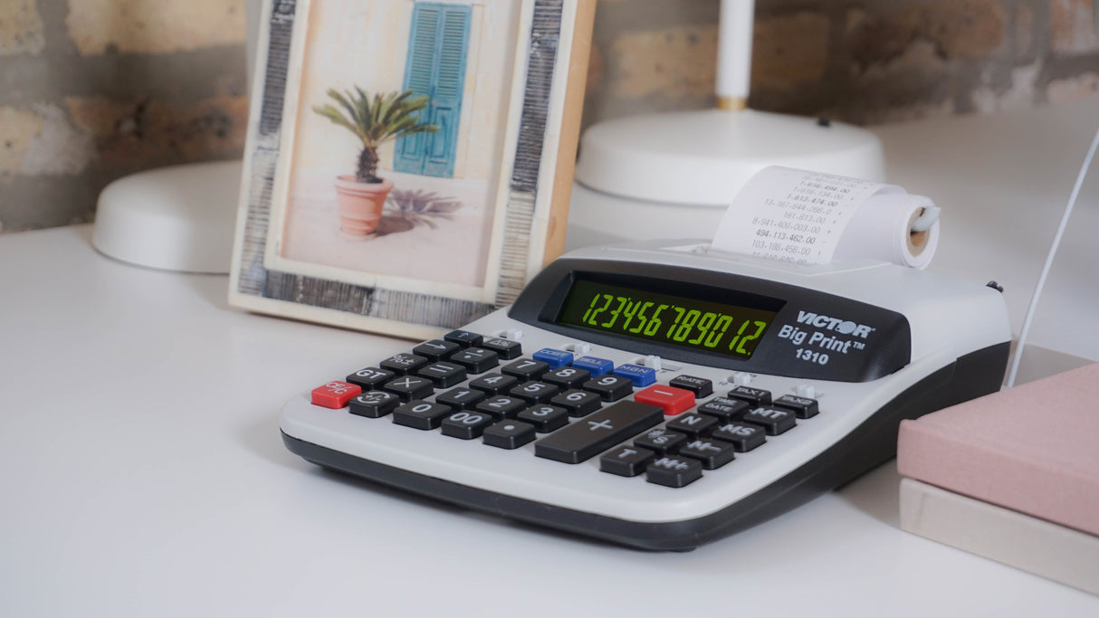 Thermal printing calculator with large display and paper roll on white office desk