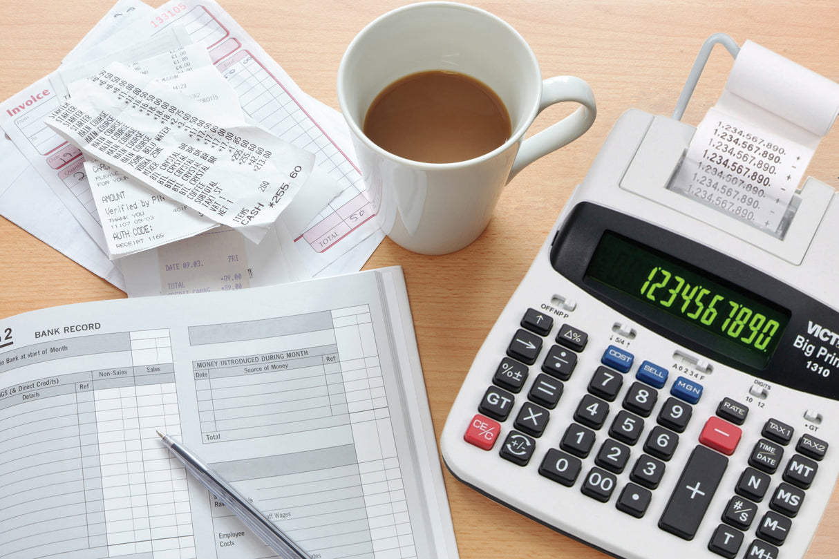 Thermal printing calculator, bank records, receipts, and coffee on office desk