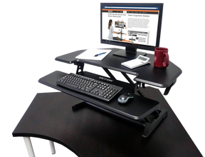 Victor® High Rise adjustable height corner standing desk with keyboard tray and monitor